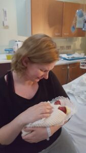 Julia holding her twin daughters who were born prematurely at 20 weeks.